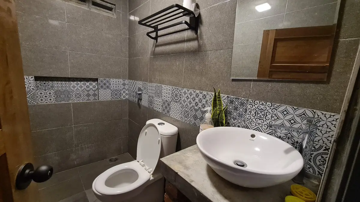 Bathroom with patterned Peranakan-style tiles and vessel sink