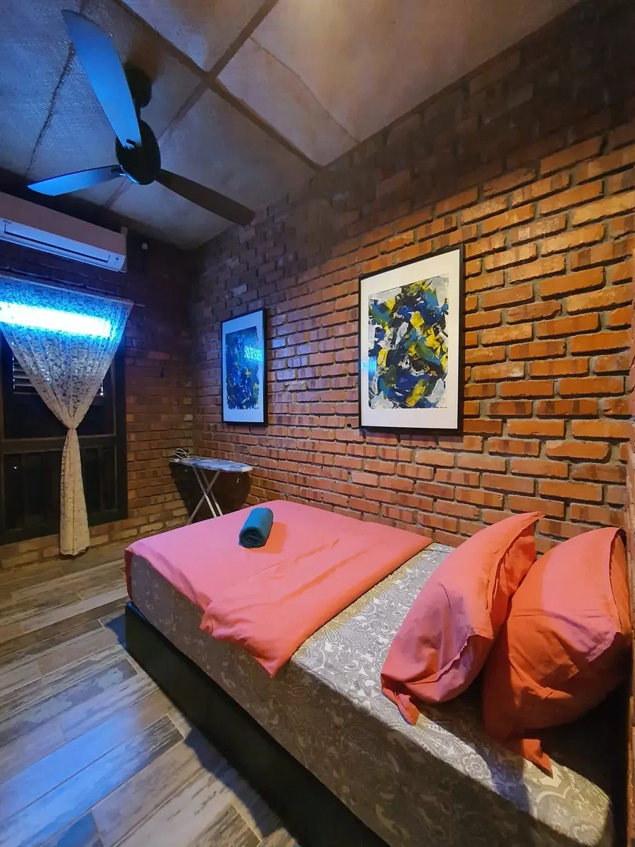 Queen bedroom with brick feature wall and ceiling fan