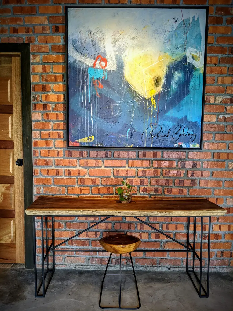 Live-edge console table beneath an abstract painting
