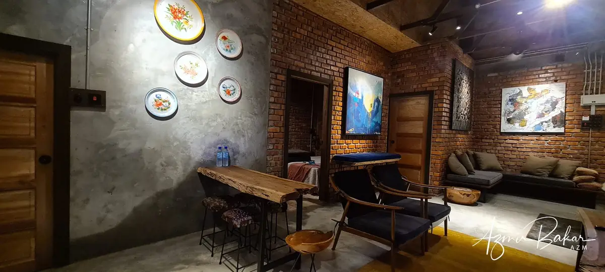 Wide view of the living space with enamel plates, daybed sofas and artwork