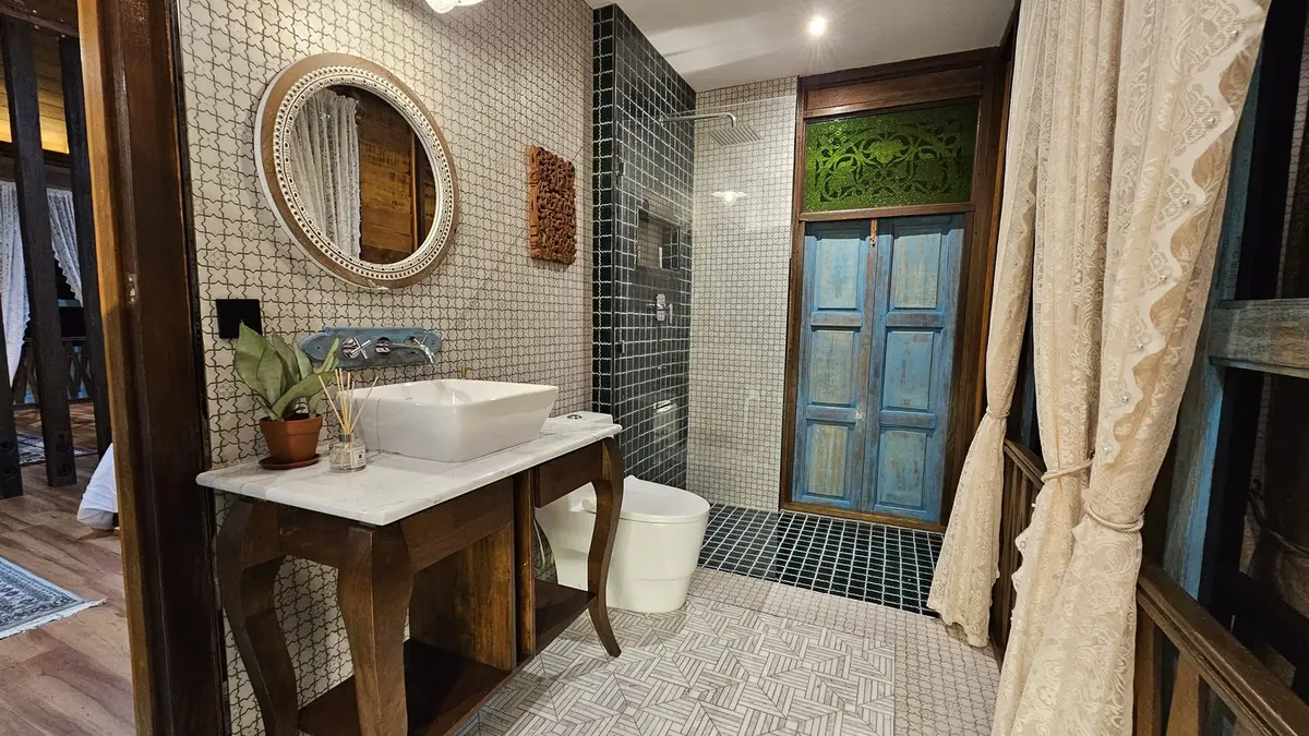 Bathroom with mosaic tiles, rain shower and a reclaimed blue door