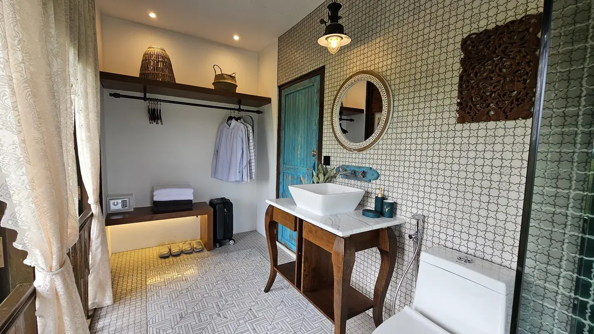 Bathroom vanity with marble top, round mirror and open wardrobe