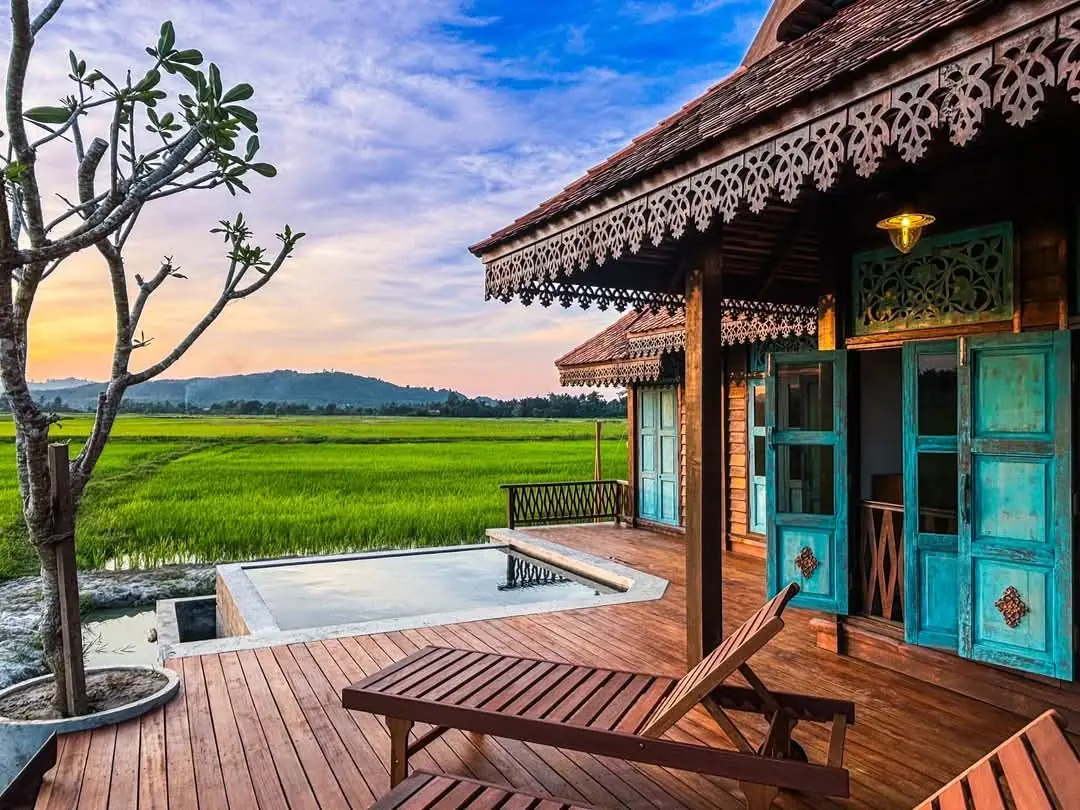 Plunge pool and deck at sunset with padi fields beyond