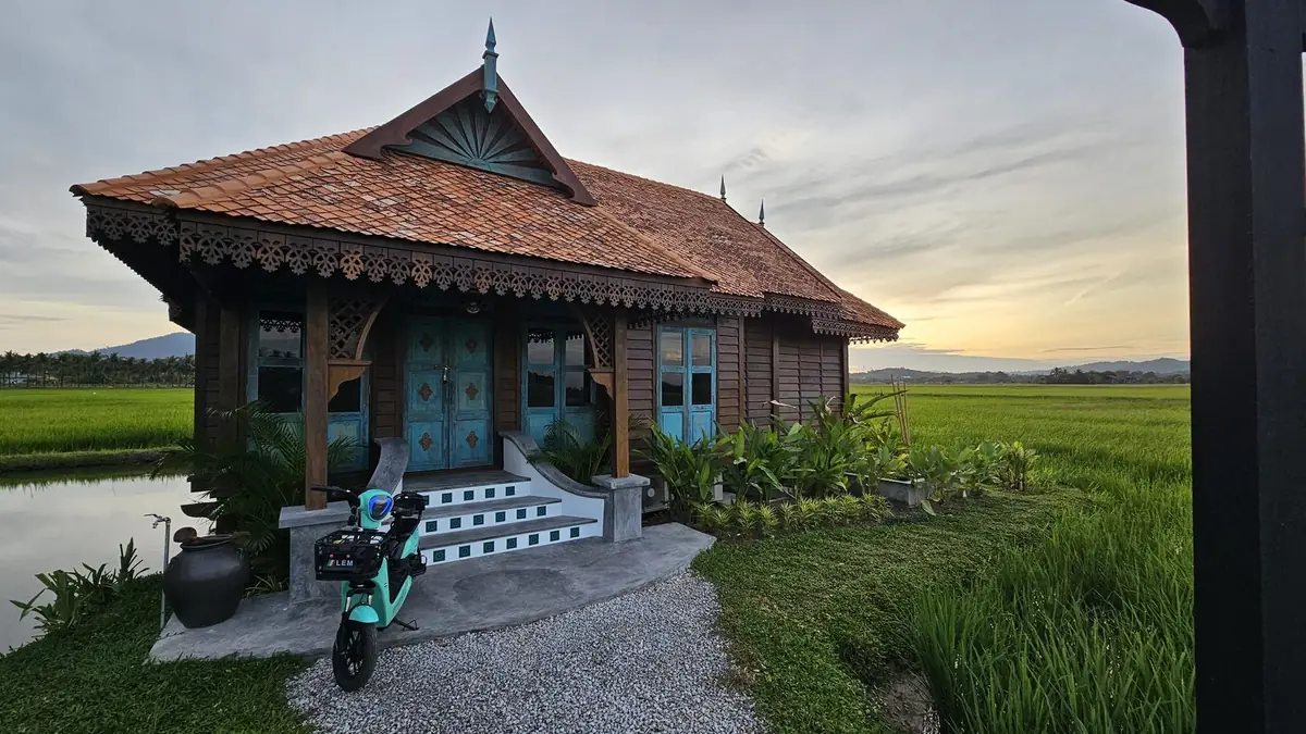 Front entrance of Rumah Uda at dusk beside the pond
