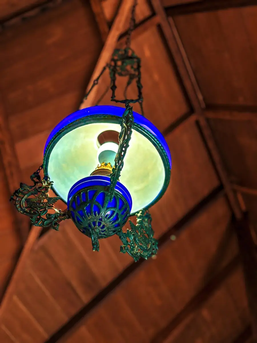 Antique blue glass ceiling lamp under the timber roof