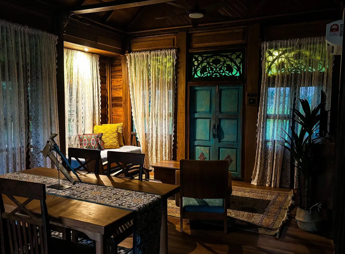 Rumah Uda at night with the interior lit and plunge pool glowing