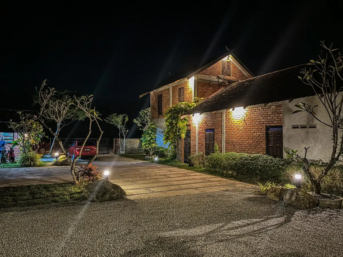 Private parking and driveway at Rumah Bendang at night