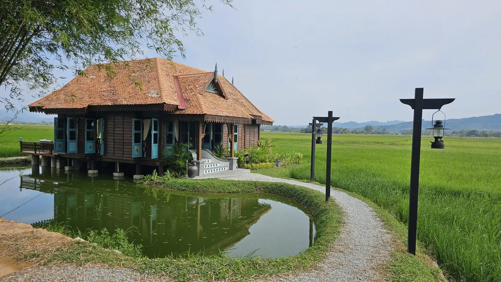 Rumah Uda, a traditional timber house on stilts over the fishing pond