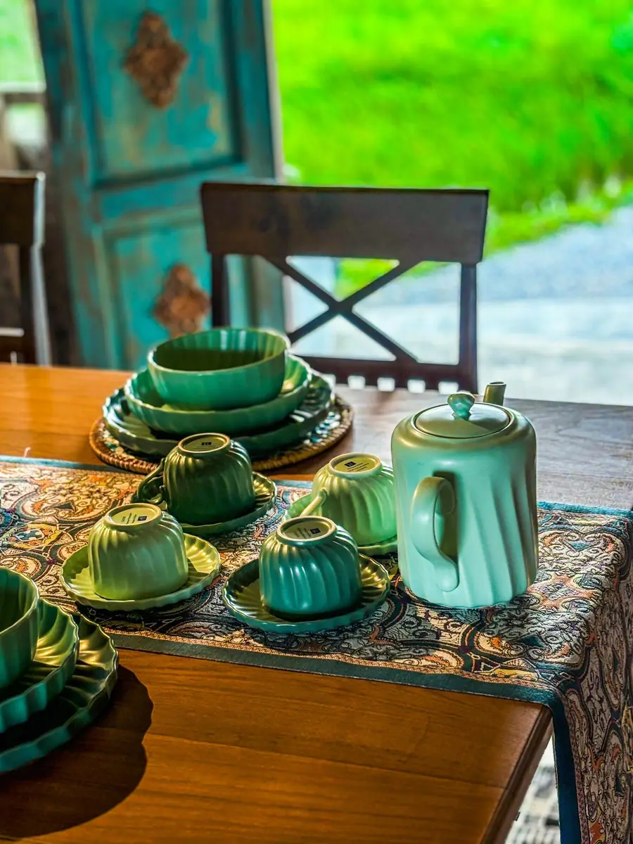 Matching teal tea set by the doorway