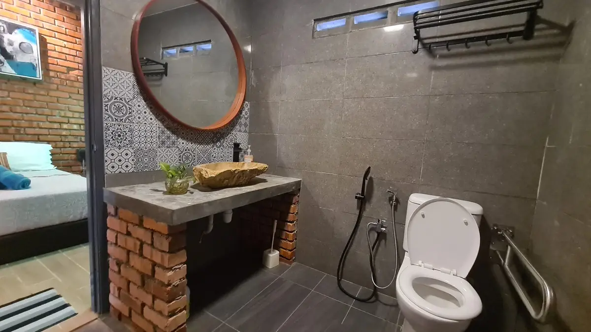Bathroom with natural stone sink and brick vanity