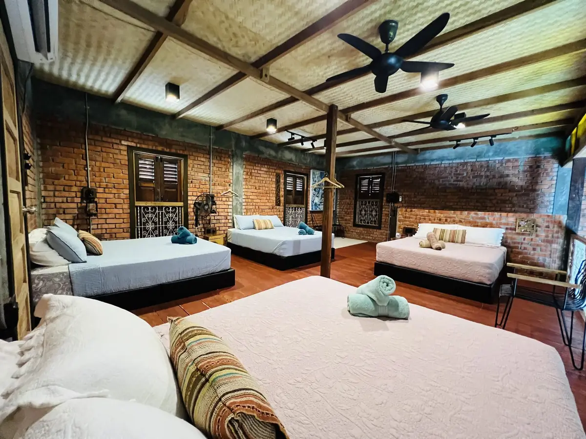 Loteng with four queen beds under a woven bamboo ceiling