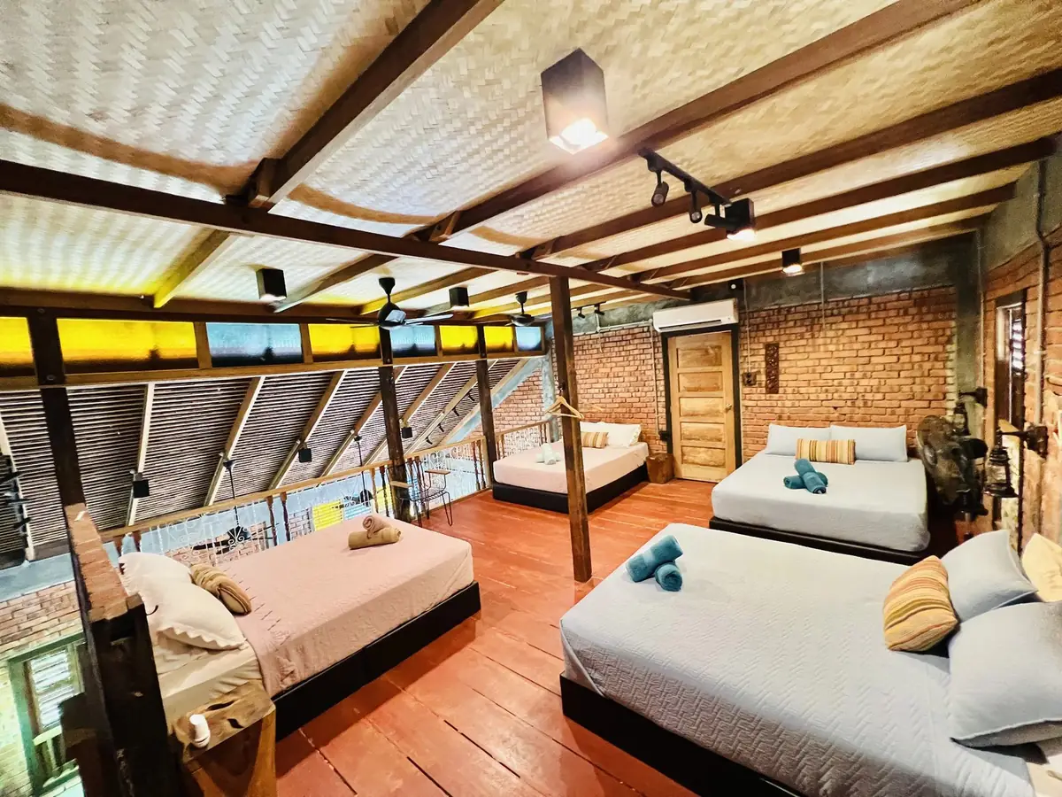 Loft bedroom with stained glass panels and reclaimed timber railing