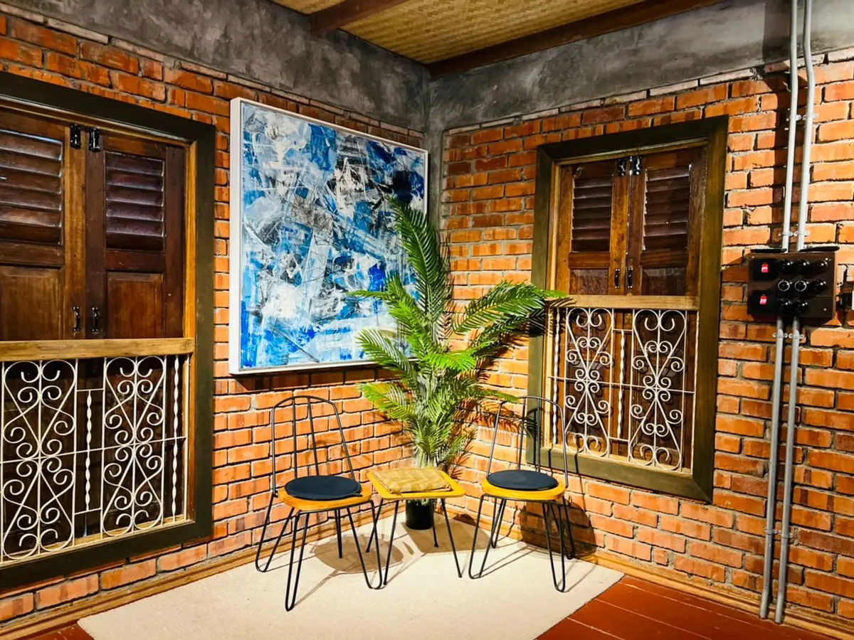 Sitting corner with wrought iron window grilles and artwork