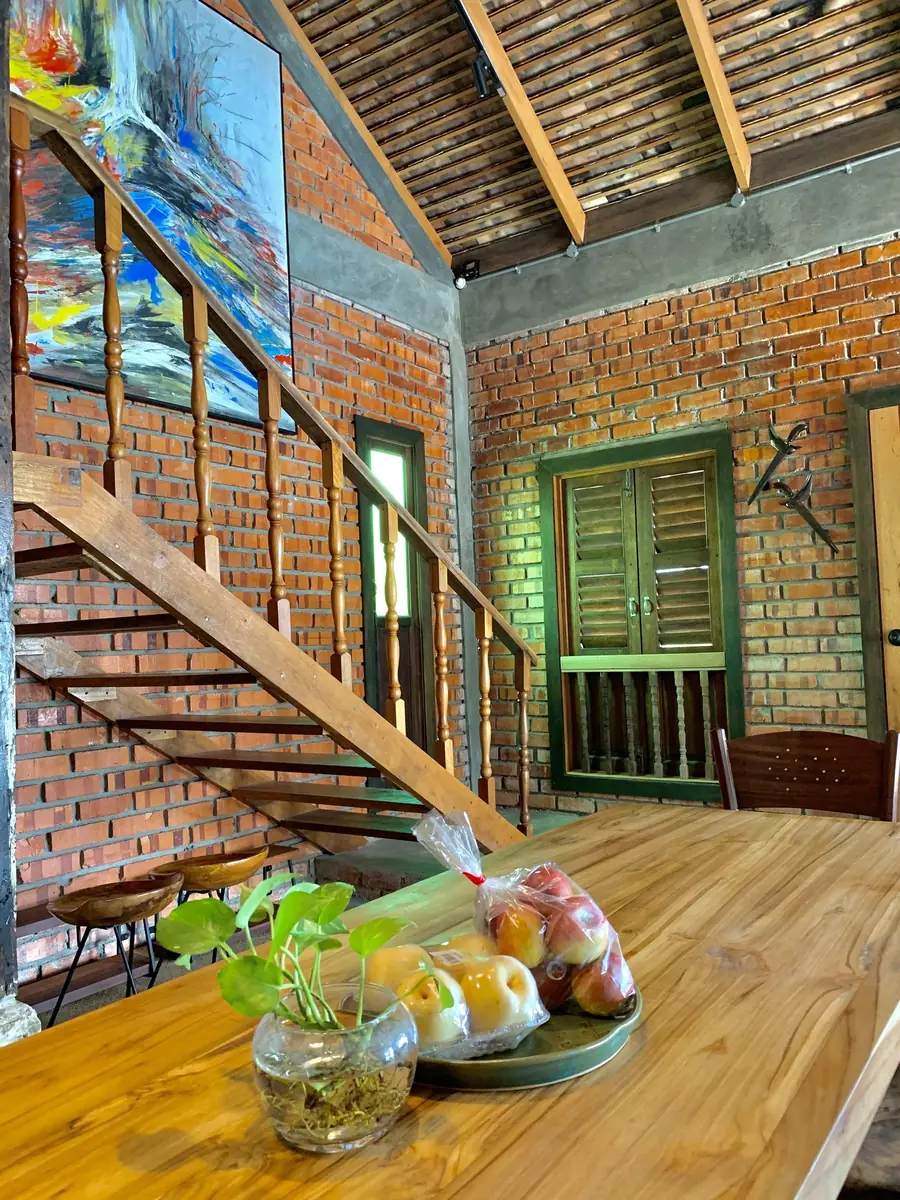 Reclaimed timber staircase with abstract artwork on the brick wall